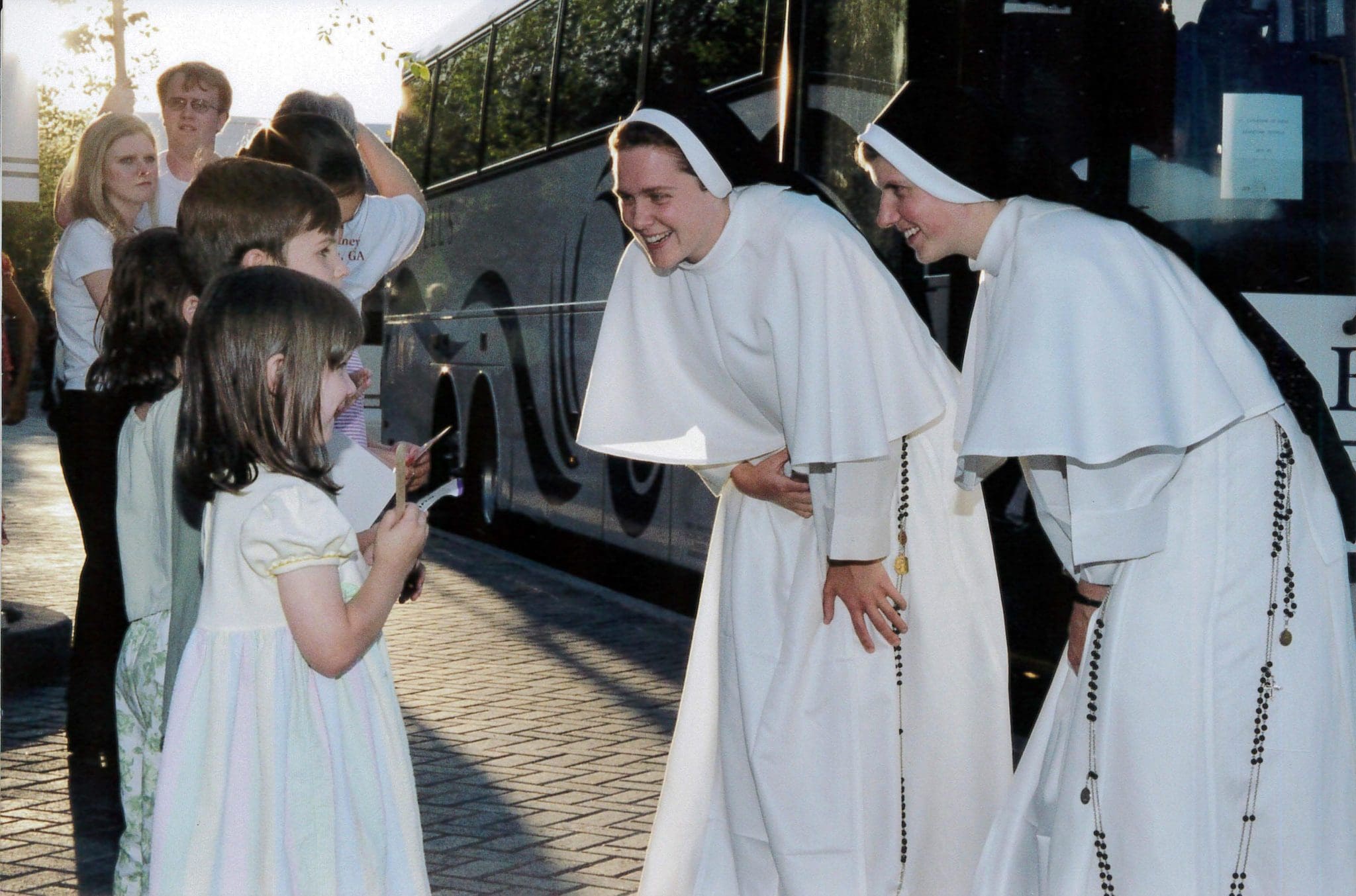 Sister Cecilia Joseph, OP, left, and Sister Anastasia, OP, converse with a litter girl at the Eucharistic Congress at the Georgia International Congress Center. [See Georgia Bulletin: April 29, 2004]