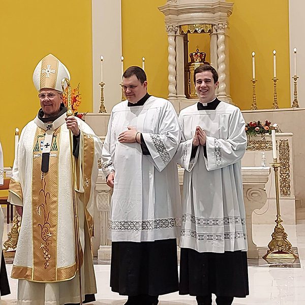 Seminarian Jacob Butz serving mass with Archbishop Hartmayer