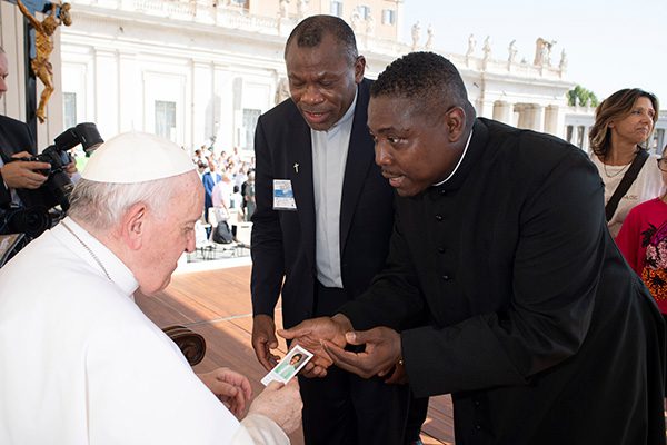Father Mark presenting to Pope Francis
