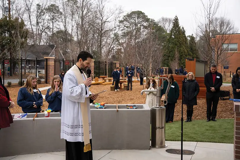 priest-stands-outside-with-others