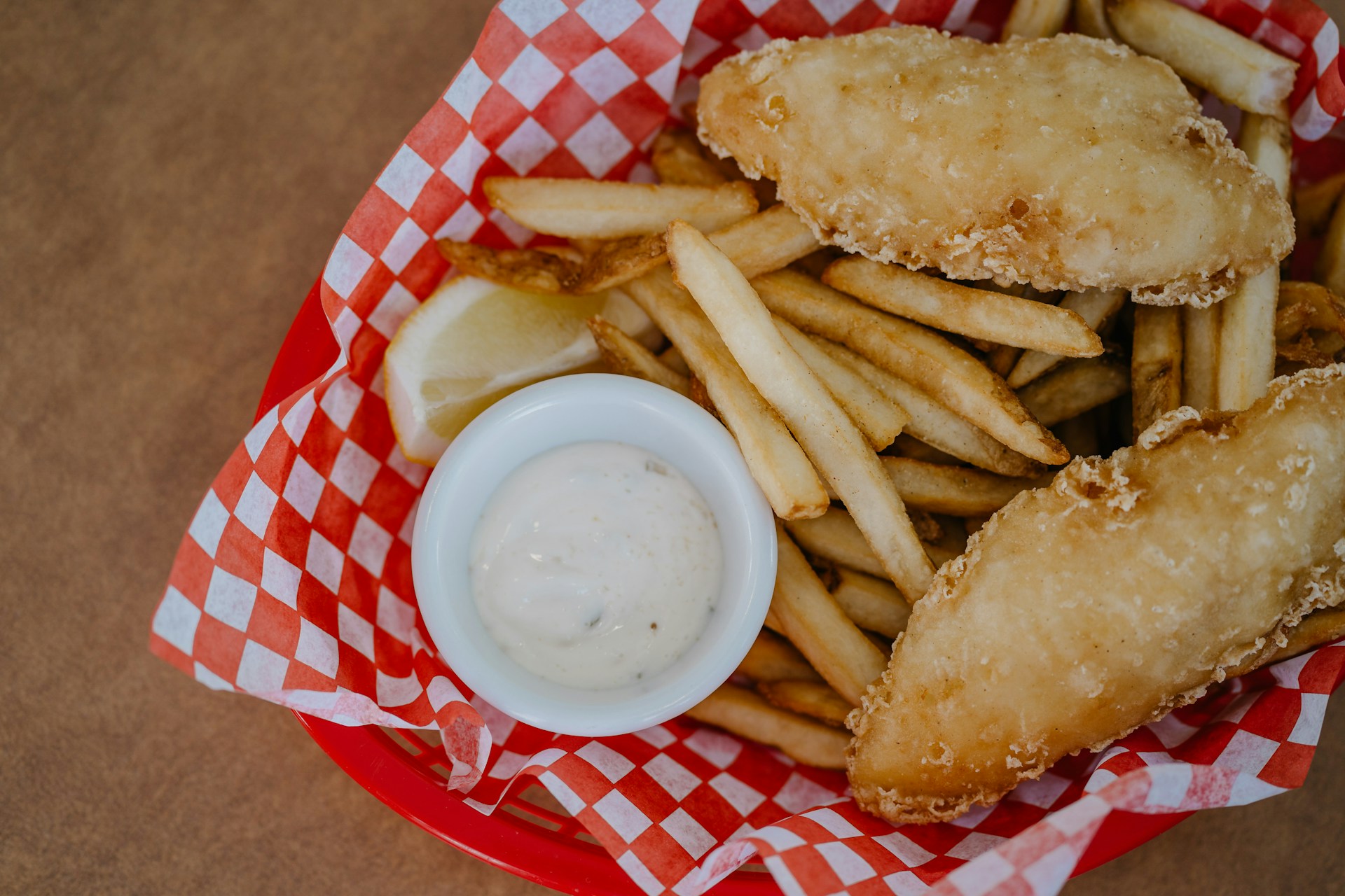 fish-and-fries-in-basket-with-condiment-sauce