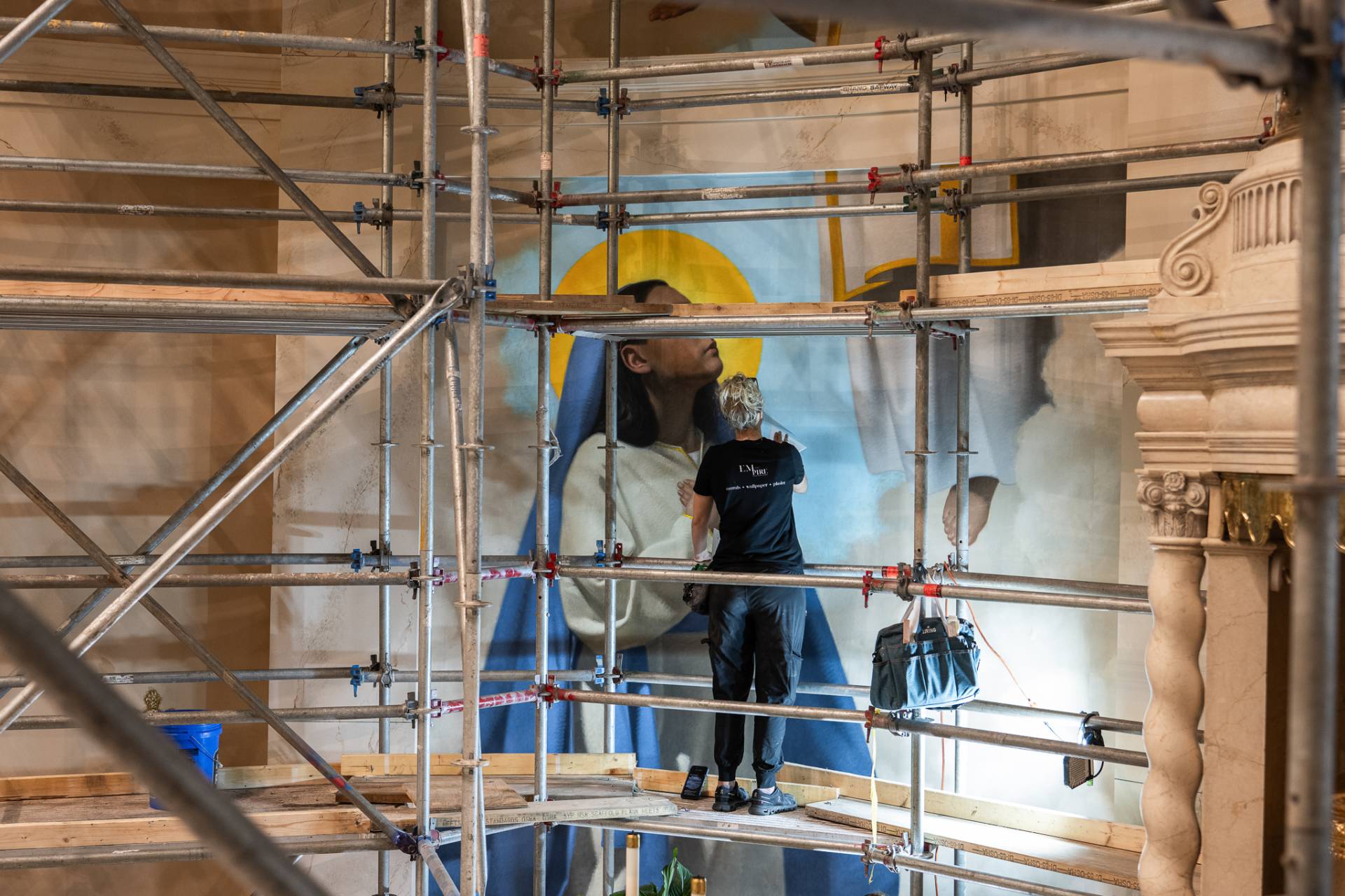 An artists works to install murals of Mary at Mary Our Queen Catholic Church.